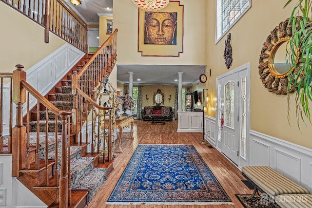 9 Narrow Brook Ct, Plainsboro, NJ 08536 - entrance foyer featuring a high ceiling, plenty of natural light, wainscoting, stairs, and wood finished floors