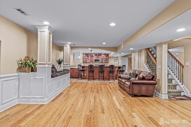 9 Narrow Brook Ct, Plainsboro, NJ 08536 - living area featuring wet bar, light wood-type flooring, decorative columns, stairway, and recessed lighting