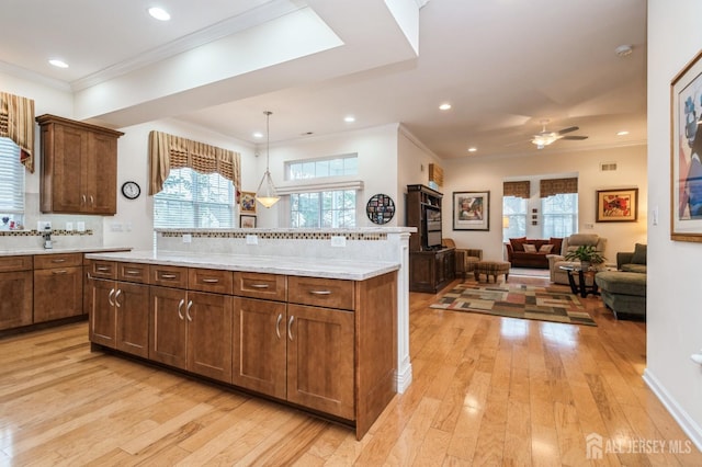 kitchen featuring a center island, pendant lighting, light hardwood / wood-style flooring, and decorative backsplash