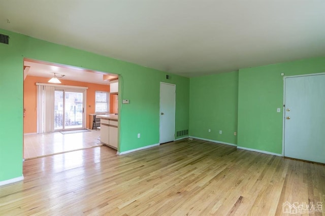 182 Evergreen Rd Unit 9A, Edison, NJ 08837 - unfurnished living room with light wood-type flooring, baseboards, and arched walkways