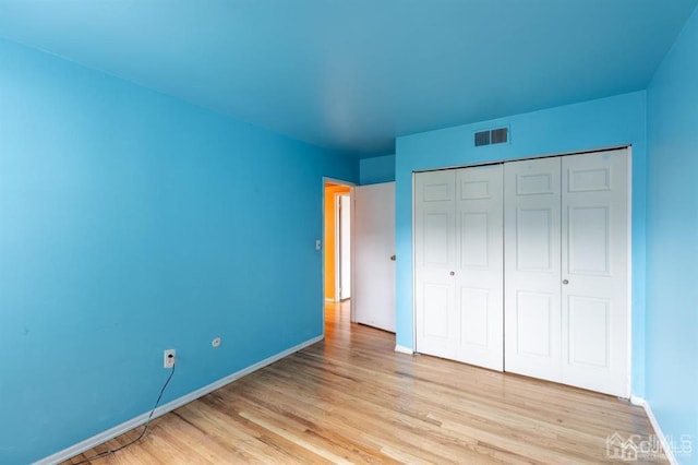 182 Evergreen Rd Unit 9A, Edison, NJ 08837 - unfurnished bedroom featuring light wood-style flooring, baseboards, and a closet