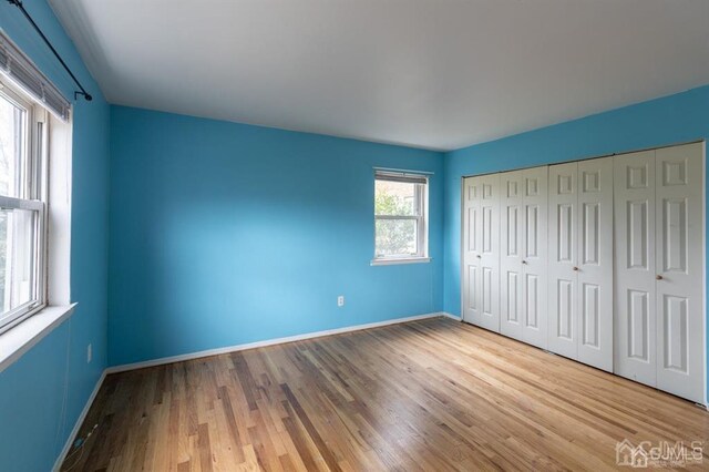 182 Evergreen Rd Unit 9A, Edison, NJ 08837 - unfurnished bedroom featuring wood finished floors, baseboards, and a closet