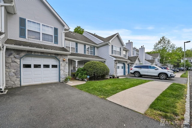 82 Heather Ct, South Brunswick, NJ 08852 - multi unit property featuring stone siding, a garage, asphalt driveway, a front lawn, and a residential view