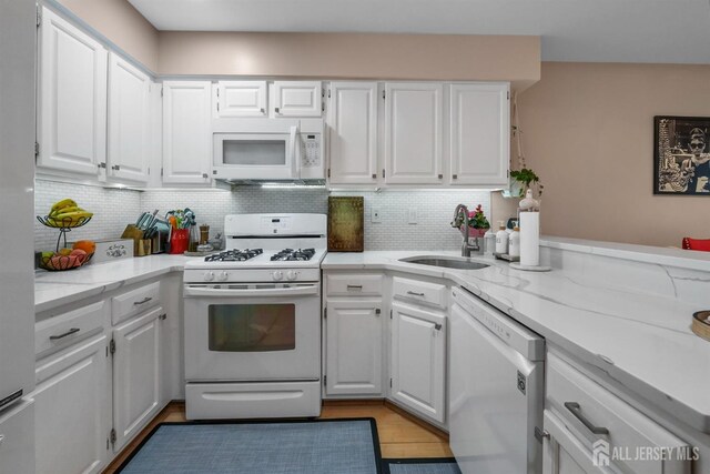 82 Heather Ct, South Brunswick, NJ 08852 - kitchen with white appliances, a sink, white cabinets, and backsplash