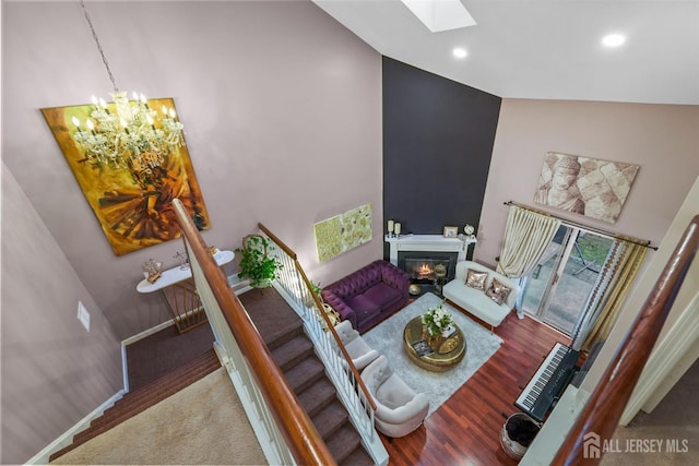 82 Heather Ct, South Brunswick, NJ 08852 - living room with a skylight, a chandelier, a glass covered fireplace, recessed lighting, and high vaulted ceiling