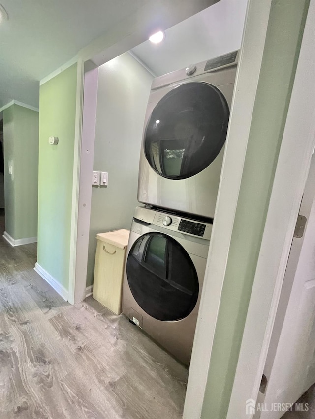 23 Hanover Sq Unit 23D, Middlesex, NJ 08846 - laundry area featuring estacked washer and dryer, wood finished floors, and ornamental molding