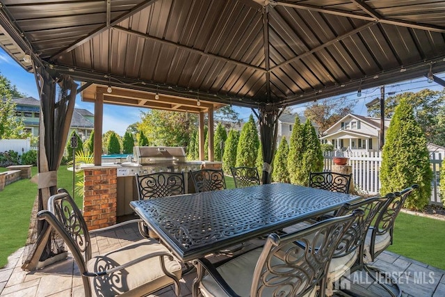 view of patio / terrace featuring a gazebo, area for grilling, outdoor dining area, and fence