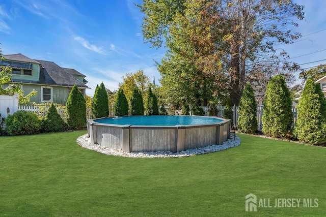 pool with a yard and fence