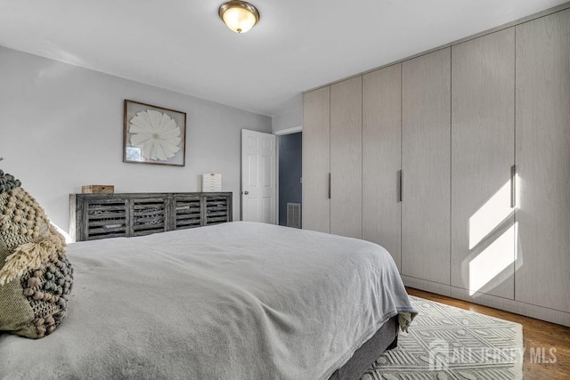 bedroom with wood finished floors and visible vents