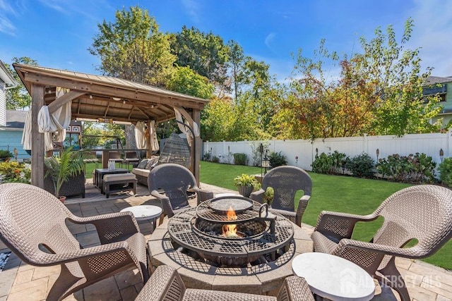 view of patio / terrace featuring a gazebo, an outdoor living space with a fire pit, and a fenced backyard