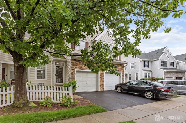 1905 Dahlia Cir S, Brunswick, NJ 08810 - view of front facade with stone siding, driveway, and a garage