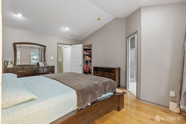 1905 Dahlia Cir S, Brunswick, NJ 08810 - bedroom featuring light wood-type flooring, vaulted ceiling, a walk in closet, recessed lighting, and a closet