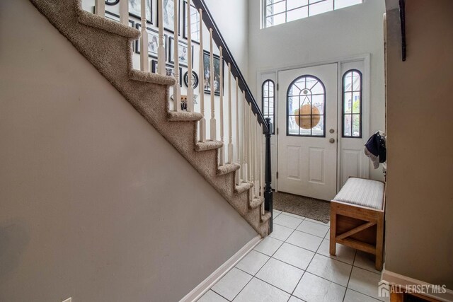 20 N Shore Blvd Unit B, Helmetta, NJ 08828 - foyer entrance with healthy amount of natural light, stairway, light tile patterned floors, and a high ceiling