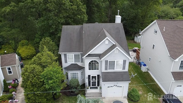 20 N Shore Blvd Unit B, Helmetta, NJ 08828 - view of front of property featuring a garage, a chimney, and driveway