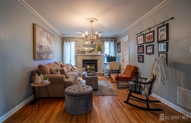 20 N Shore Blvd Unit B, Helmetta, NJ 08828 - living area featuring wood finished floors, ornamental molding, a chandelier, and a brick fireplace