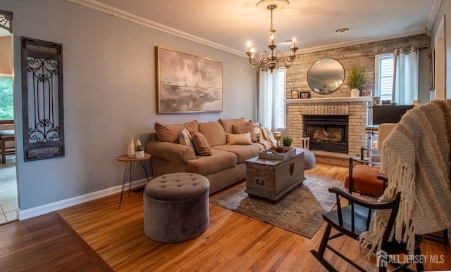 20 N Shore Blvd Unit B, Helmetta, NJ 08828 - living room featuring ornamental molding, wood finished floors, a chandelier, and a fireplace