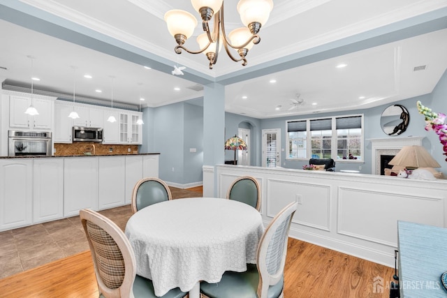 10 E Black Heath Ct, Howell, NJ 07727 - dining room with a chandelier, light wood-style flooring, crown molding, recessed lighting, and a ceiling fan