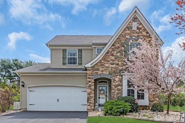 10 E Black Heath Ct, Howell, NJ 07727 - view of front of property featuring stone siding, asphalt driveway, a shingled roof, and an attached garage