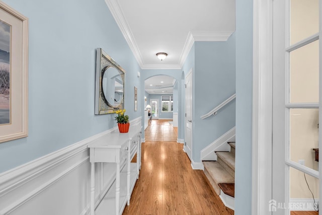 10 E Black Heath Ct, Howell, NJ 07727 - hallway featuring arched walkways, ornamental molding, light wood-type flooring, and stairway