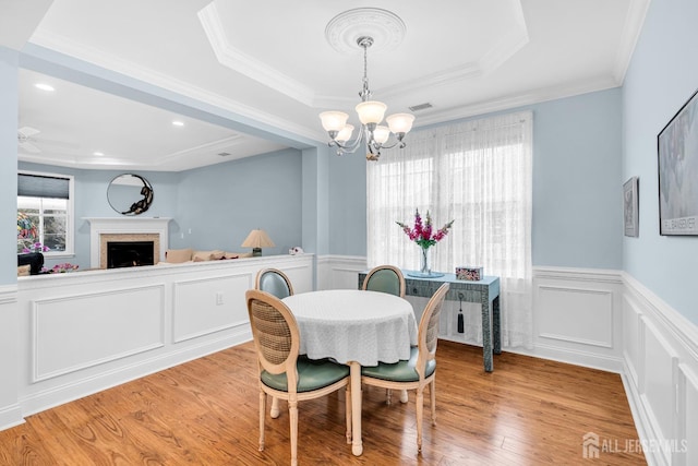 10 E Black Heath Ct, Howell, NJ 07727 - dining space featuring a chandelier, a decorative wall, a fireplace, wood finished floors, and wainscoting