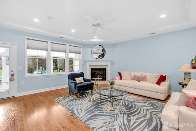10 E Black Heath Ct, Howell, NJ 07727 - living area featuring a tray ceiling, ceiling fan, wood finished floors, recessed lighting, and a glass covered fireplace