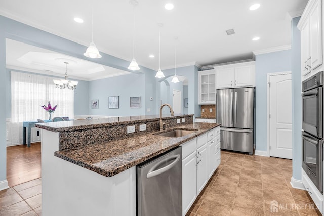 10 E Black Heath Ct, Howell, NJ 07727 - kitchen featuring appliances with stainless steel finishes, arched walkways, white cabinetry, a center island with sink, and glass insert cabinets