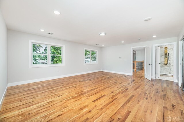 unfurnished room with light wood-type flooring