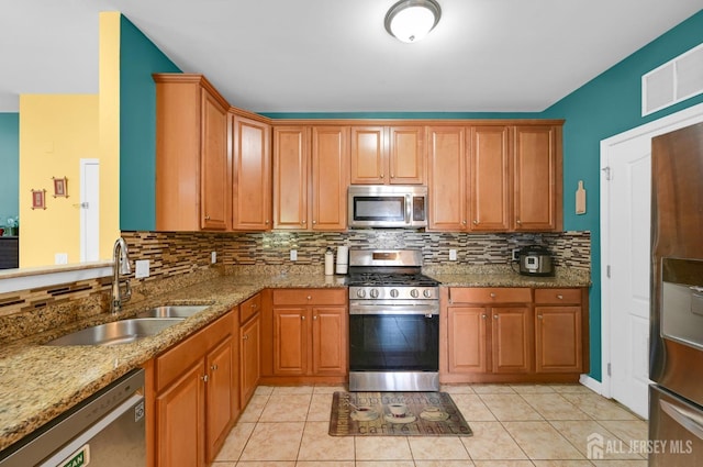2022 Edward Stec Blvd, Edison, NJ 08837 - kitchen featuring appliances with stainless steel finishes, a sink, backsplash, light stone countertops, and light tile patterned flooring