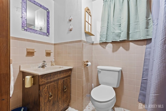 75 Princeton Rd, Old Bridge, NJ 08859 - full bathroom featuring tile walls, toilet, vanity, and a wainscoted wall