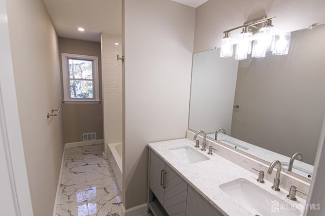 6 Joan St, South Brunswick, NJ 08824 - bathroom with baseboards, visible vents, marble finish floor, and a sink