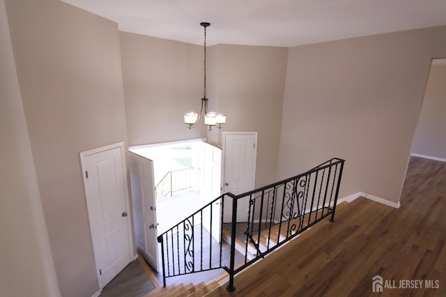6 Joan St, South Brunswick, NJ 08824 - staircase featuring a towering ceiling, a notable chandelier, wood finished floors, and baseboards