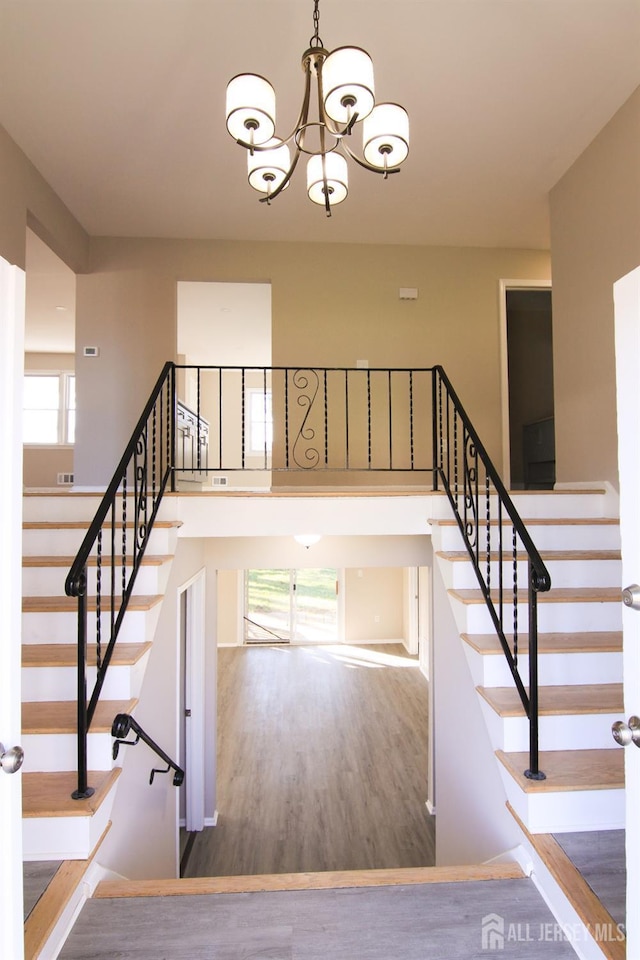 6 Joan St, South Brunswick, NJ 08824 - stairs with wood finished floors, an inviting chandelier, and a high ceiling