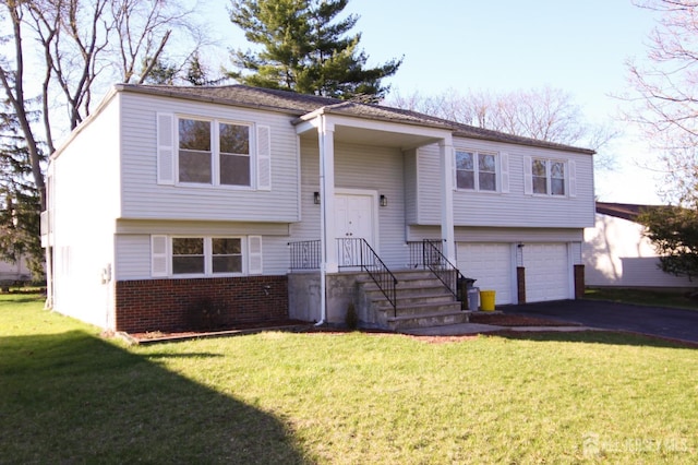 6 Joan St, South Brunswick, NJ 08824 - raised ranch featuring brick siding, aphalt driveway, a front yard, and an attached garage