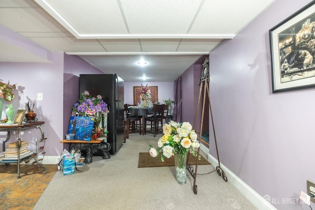 interior space with carpet floors and baseboards