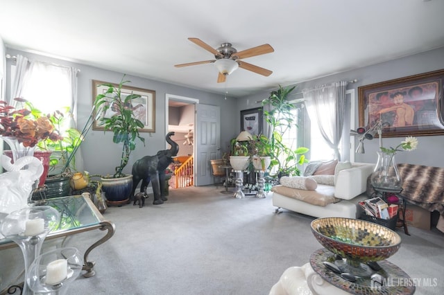 living room with ceiling fan, carpet flooring, and a healthy amount of sunlight