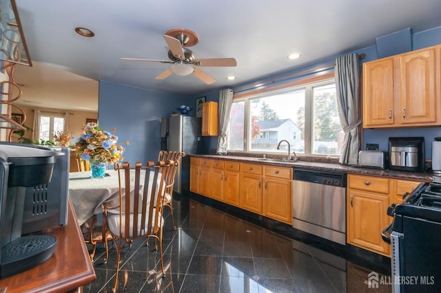 kitchen with recessed lighting, dark countertops, granite finish floor, a sink, and dishwasher