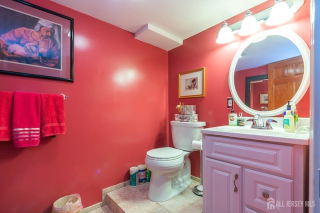 bathroom with toilet and vanity