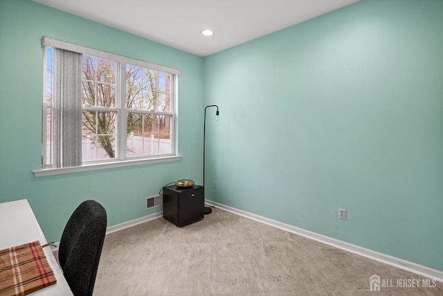 unfurnished office with baseboards, visible vents, carpet floors, and recessed lighting
