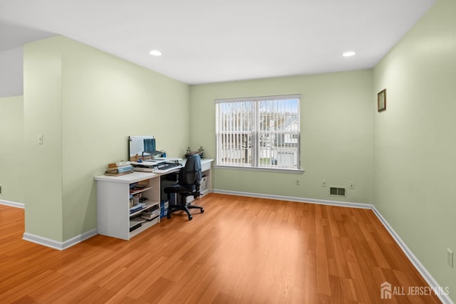 office space with visible vents, baseboards, recessed lighting, and wood finished floors