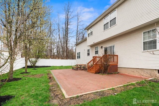 back of house with a patio area, fence, and a lawn
