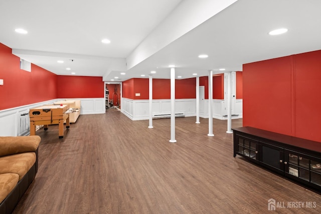 playroom featuring a decorative wall, recessed lighting, a wainscoted wall, wood finished floors, and a baseboard heating unit