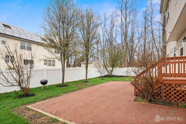 exterior space with a fenced backyard, a deck, and a patio