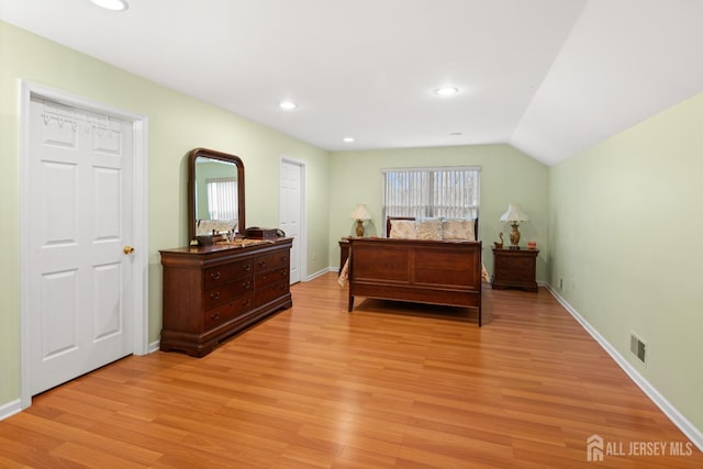 bedroom featuring baseboards, light wood-style flooring, and visible vents