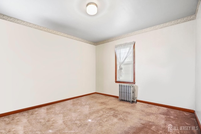 unfurnished room with carpet floors, baseboards, and radiator heating unit