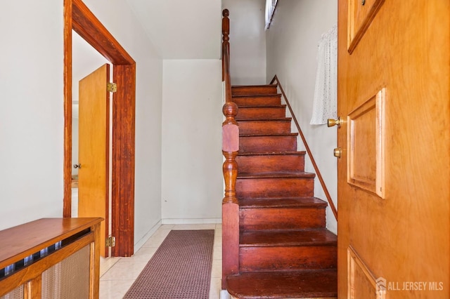 stairs with tile patterned floors