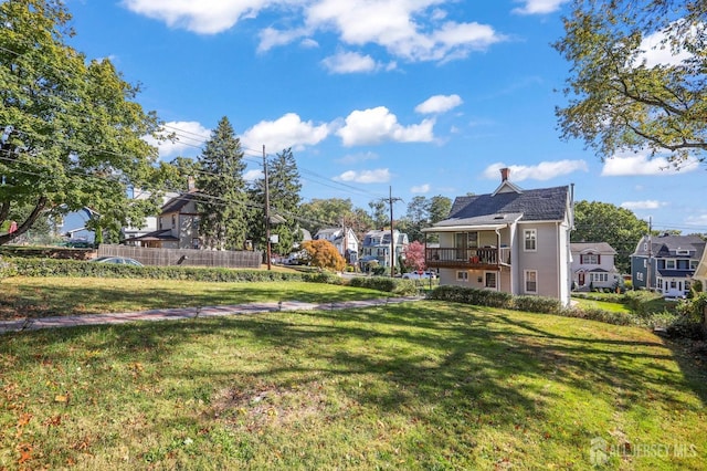 view of yard featuring a residential view and fence