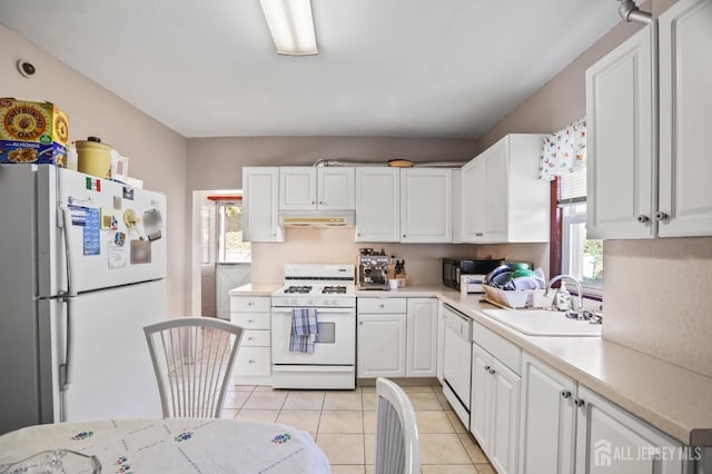 kitchen featuring under cabinet range hood, white appliances, a sink, white cabinetry, and light countertops