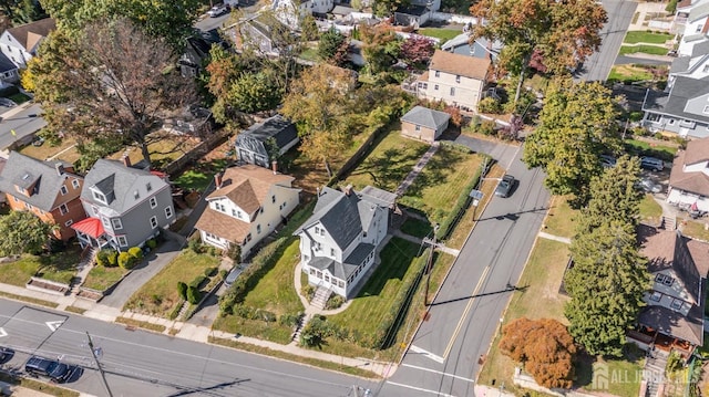 aerial view of property and surrounding area featuring nearby suburban area