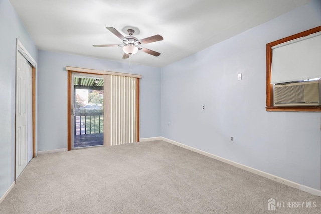 empty room featuring light carpet, ceiling fan, baseboards, and cooling unit