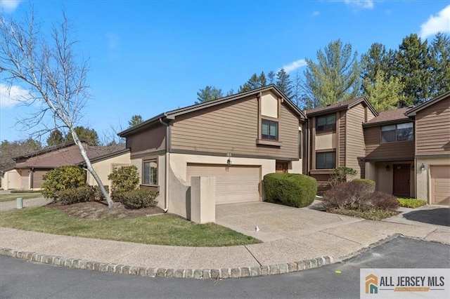 view of front of house featuring a garage, stucco siding, and concrete driveway